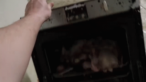 the man is using his hand to open the oven