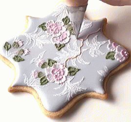 two cookies with some flowers and leaves in it
