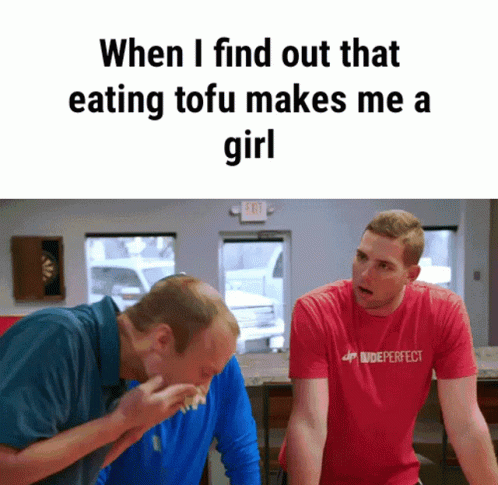 two men in a room with a sign that says when i find out that eating tofu makes me a girl