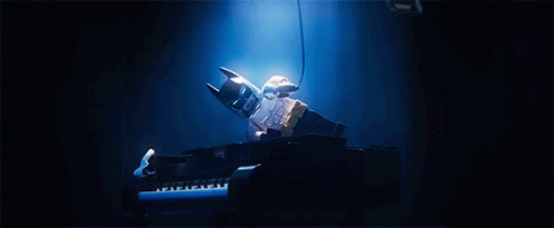 a doll is playing the piano and lights from its stand