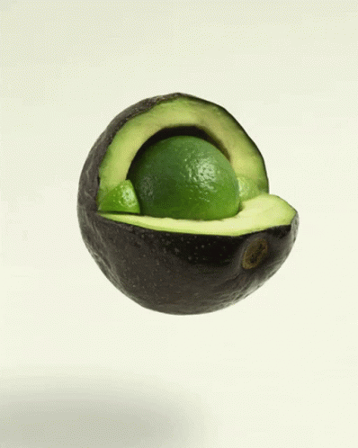 a cut of an avocado has a piece of the fruit inside it