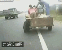 a man on a three wheeled cart riding down a highway