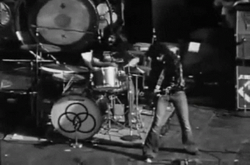 a black and white po of two guitarists on drums