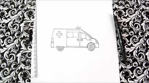 drawing of an ambulance on white paper next to black floral wallpaper