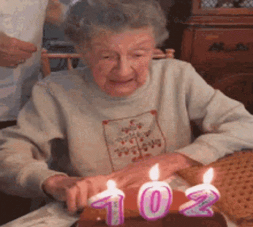 an old woman is celeting her new year with candles