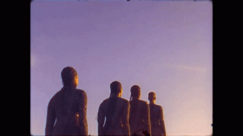 multiple statues of men walking on concrete