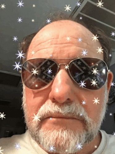 a man in sunglasses has fake stars on his face