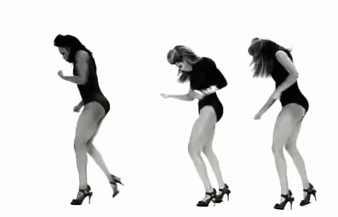 the woman is jumping while wearing black heels