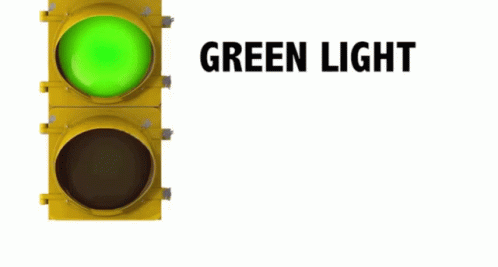 a green traffic light in front of a white background