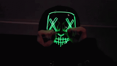 a mask with neon lines is shown in this dark room