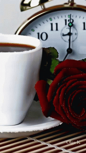 two mugs of tea and some roses on a table