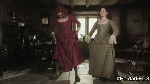 two women in long dresses walking into a house