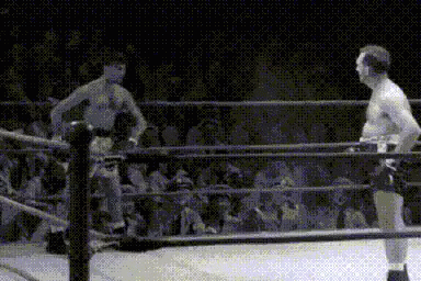 two men in a ring with two referees