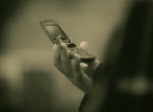 a woman using her phone to do soing in the dark