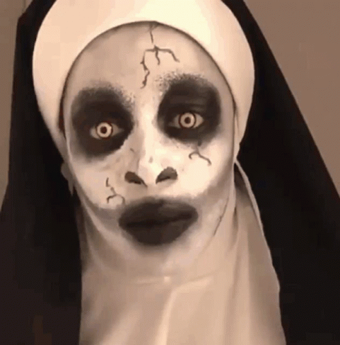 someone dressed up in a nun costume and makeup