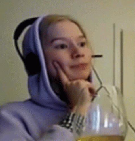 a woman wearing a hoodie while talking on the phone