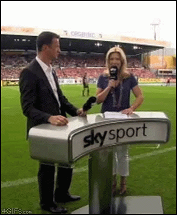 woman with blue hair speaks into a microphone from skysport announcer