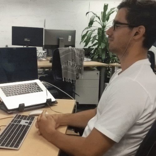 a man using a laptop computer at a desk