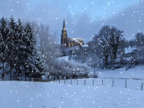 a snowy landscape with a church in the distance