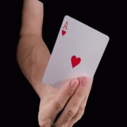 a blue gloved hand holding a three card white card