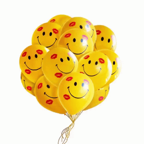a bunch of smiling face balloons are in the air