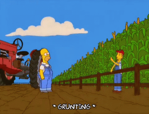 two cartoon characters standing near a giant tractor in a field