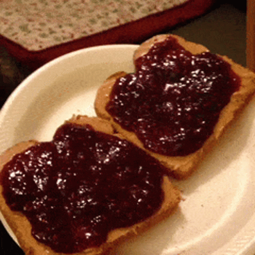 two pieces of toast with blueberry jelly on it