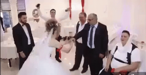 there is a man and woman dancing in a white dress