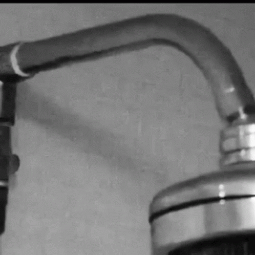a faucet and some wires attached to the wall