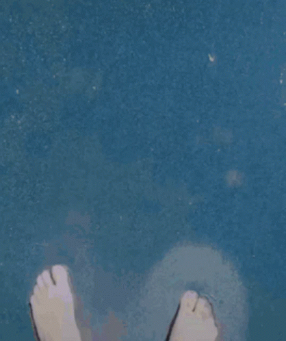 a close up po of a persons feet on a bathroom floor
