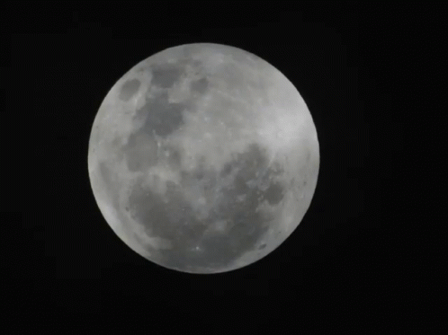 a full moon seen in the sky as it rises