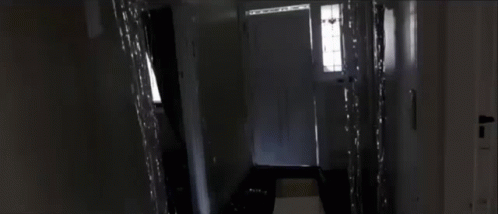 an empty hallway with a toilet and sink