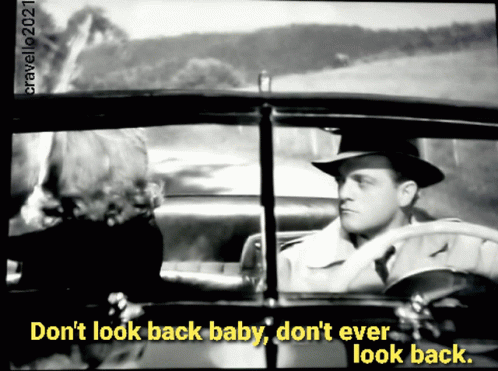 the man sitting in a car has a caption from the movie don't look back baby, don't ever look back