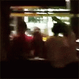 the blurry image shows people at an outdoor cafe
