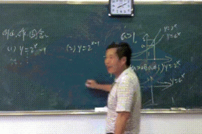 a male student stands in front of a chalkboard
