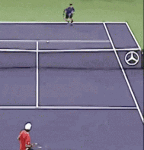 a tennis player runs after the ball that goes off the net