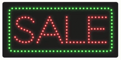 a big sale sign with green and blue lights on it