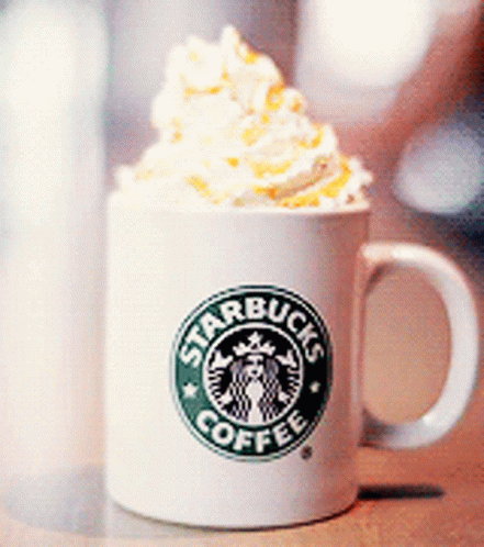 a white cup with whipped cream on top