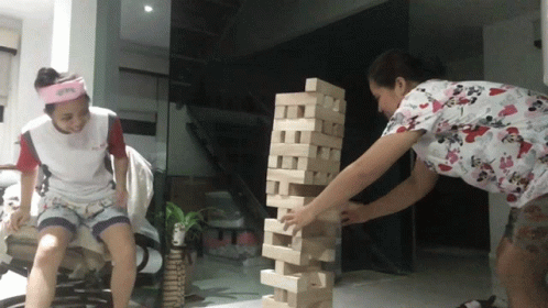 two people playing with lego blocks in a building
