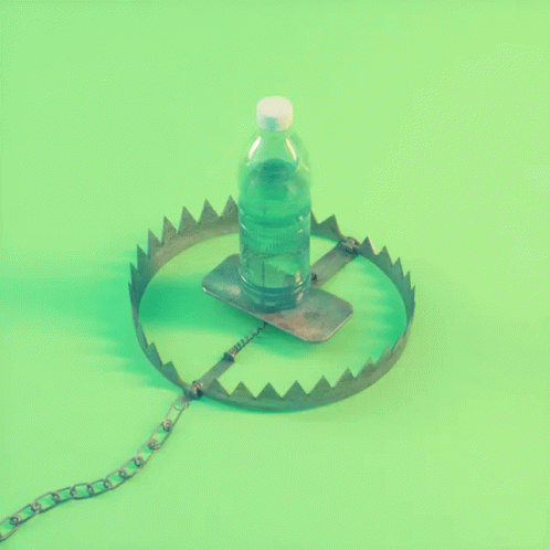 an open bottle sitting on top of a metal plate
