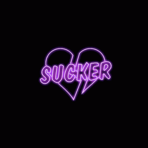 a pink and black heart shaped word that says sucker