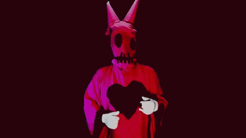 the silhouette of a person wearing a devil mask and holding a heart shaped object