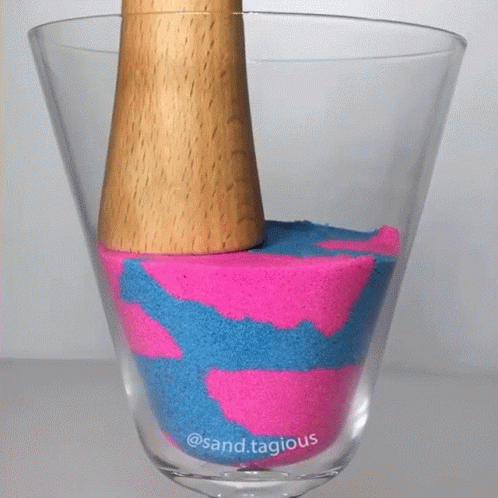 an object with yellow and blue dye is on top of a glass