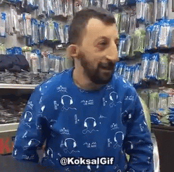a guy with blue painted face and beard wearing a sweater