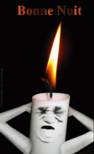 a candle with a human head and smoke coming out of it