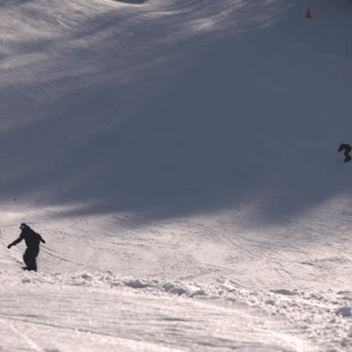 a skier going down a snowy slope on a hill