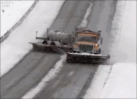 a tractor and semi hauling a snow plow