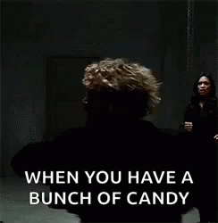 two people standing in front of an image with the caption when you have a bunch of candy
