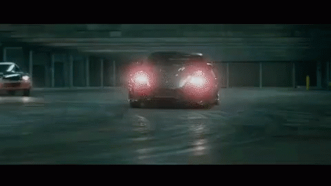 a sports car driving through a parking garage