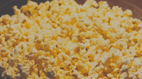 a bowl of white chocolate popcorn with blue sugar